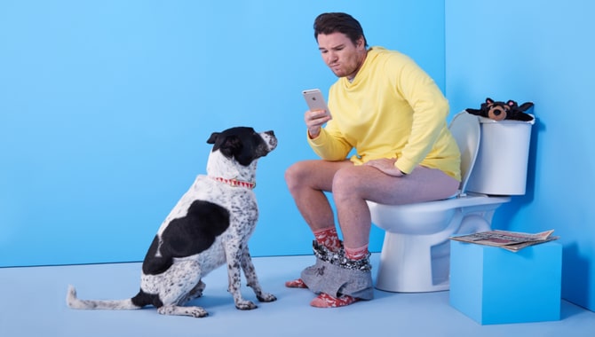 5 Common Reasons Why Dogs Sit At Your Feet In The Bathroom